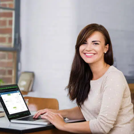 Confident, Smiling Young Woman Computer Technician In Front Of Laptop