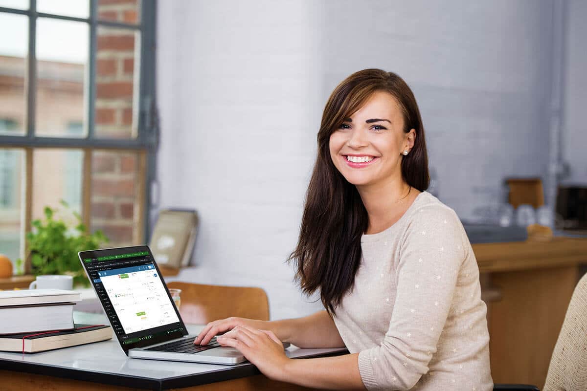 Confident, Smiling Young Woman Computer Technician In Front Of Laptop