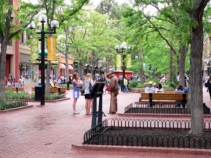 Pearl Street Mall With Street Performer and shoppers on the sidewalk in Spring