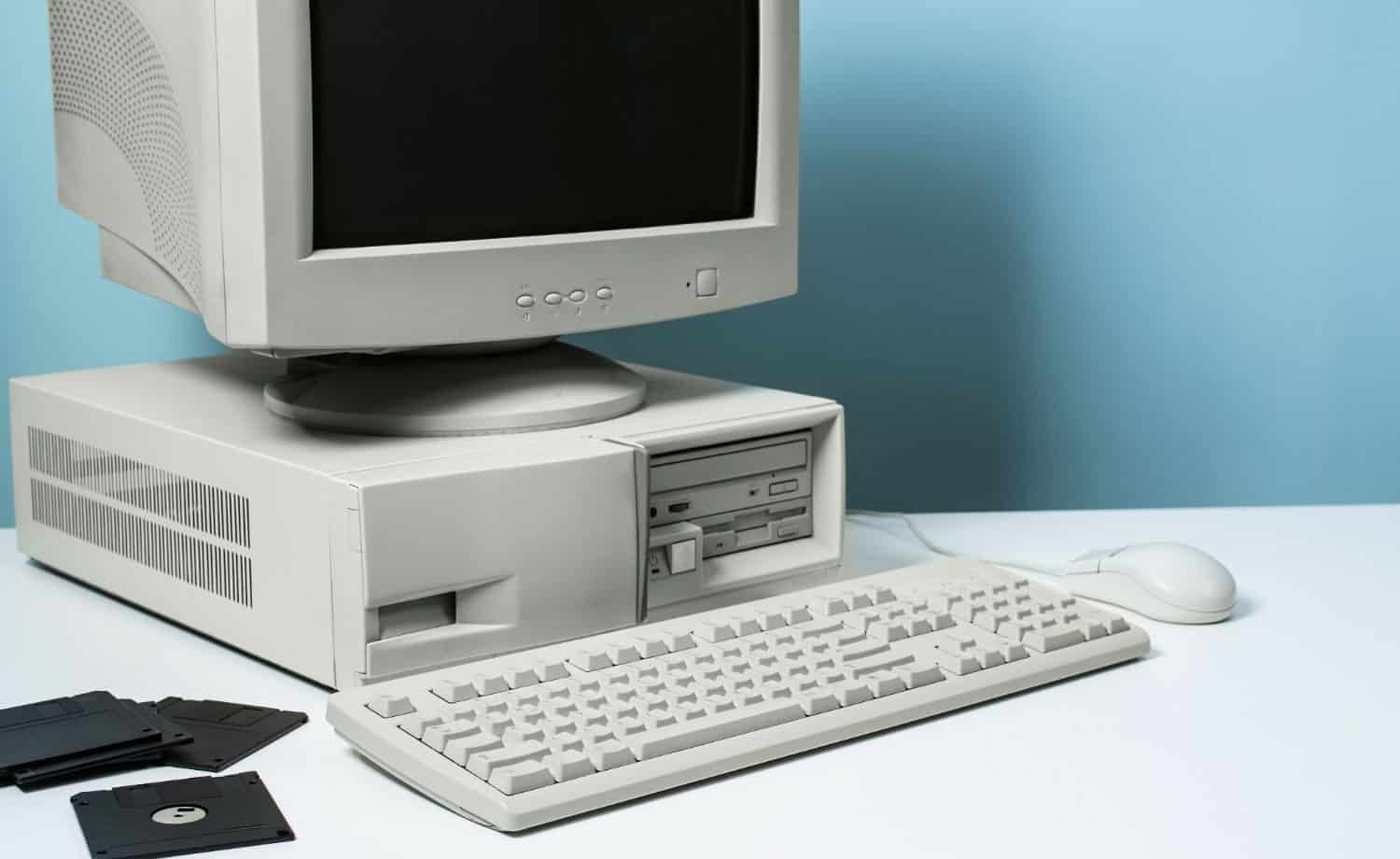 Old school beige box desktop with CRT monitor and floppy disks.
