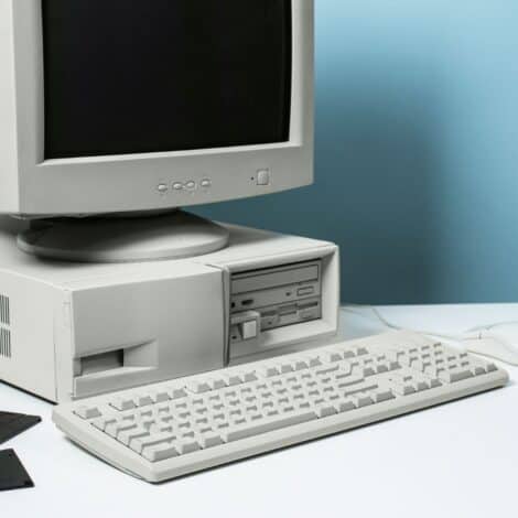 Old school beige box desktop with CRT monitor and floppy disks.