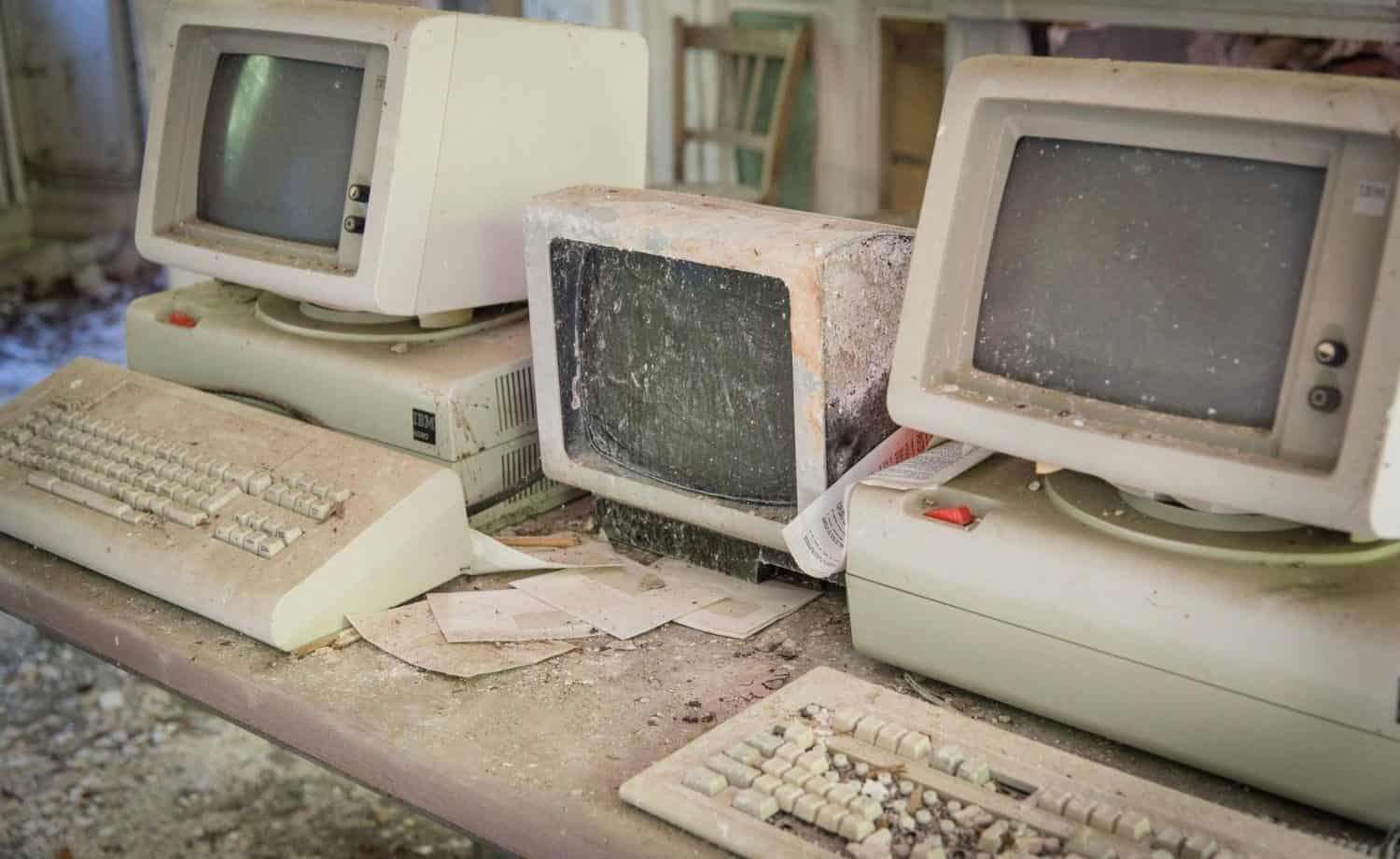 Vintage, dusty broken computers on a desk