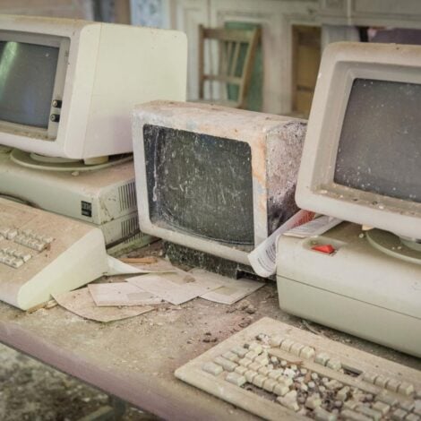 Vintage, dusty broken computers on a desk
