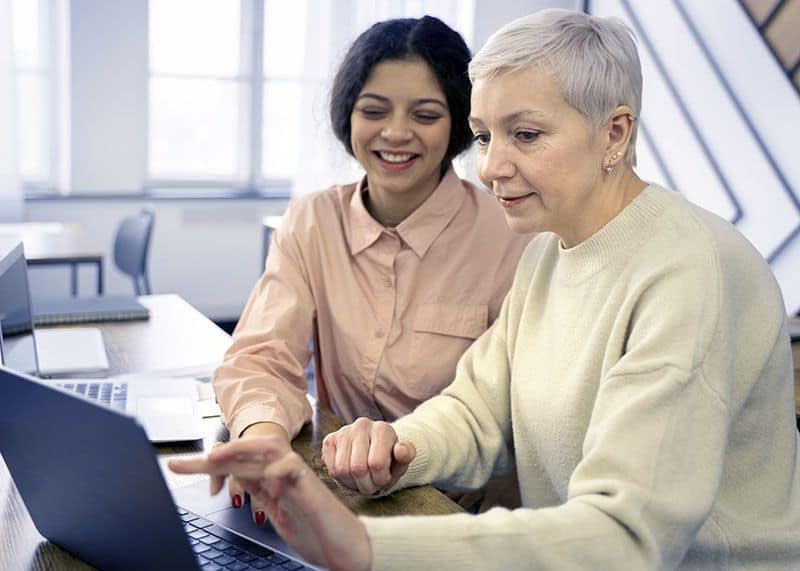 Home Computer Services - Woman Helping Senior to Use Her Computer