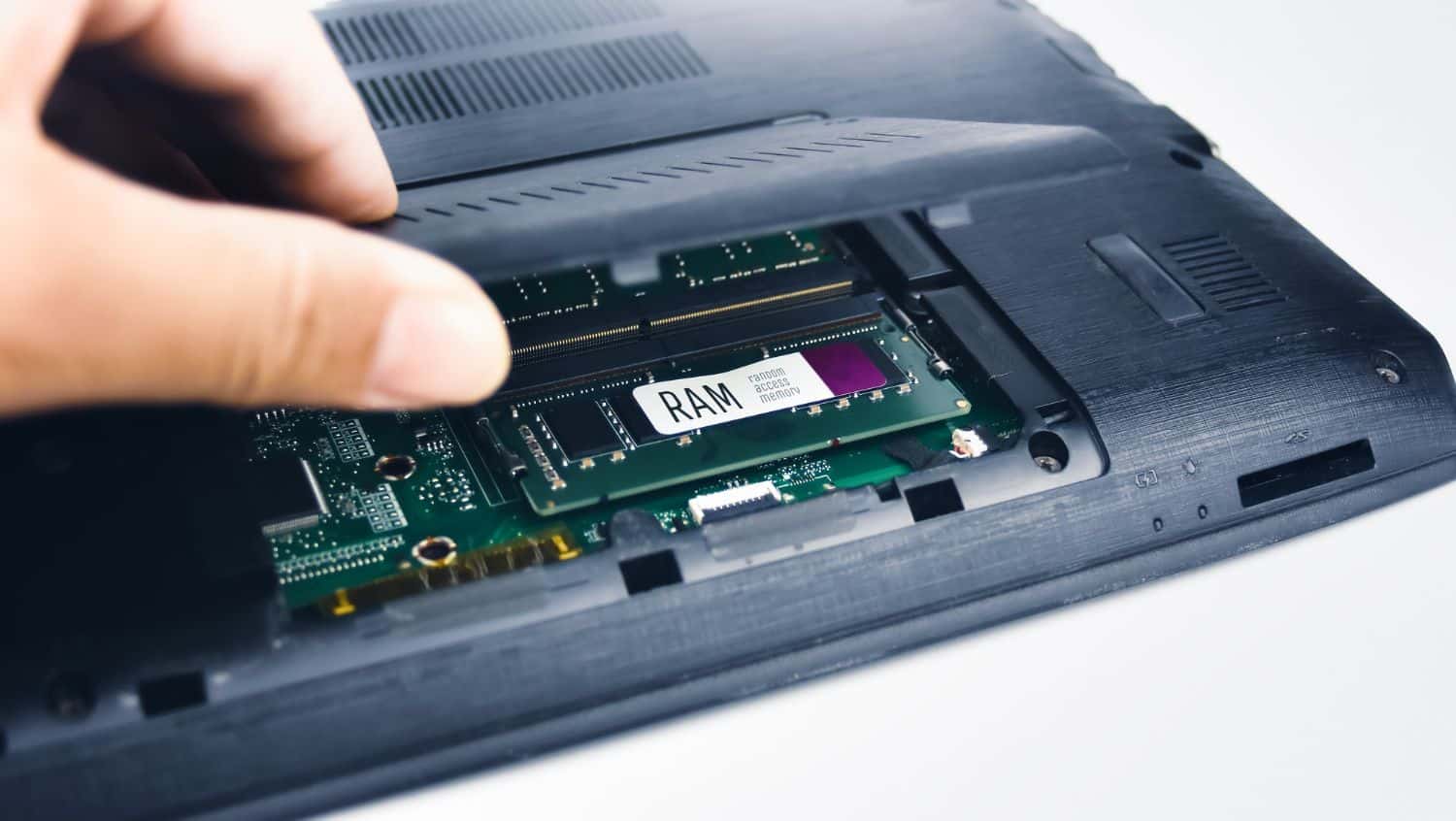 Laptop with RAM tray opened.