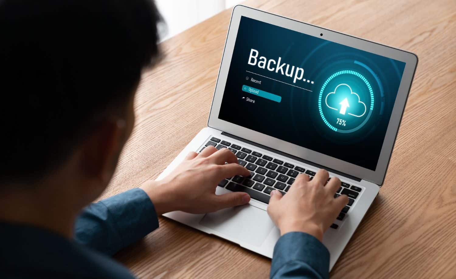 man performing a data backup on his laptop