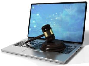 Laptop with a judge's gavel on it to signify the legal risks of unsecured home networks