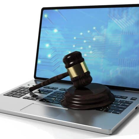 Laptop with a judge's gavel on it to signify the legal risks of unsecured home networks
