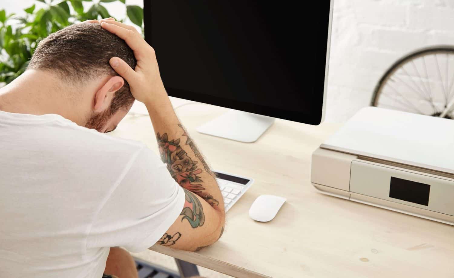 Man frustrated by computer that won't turn on