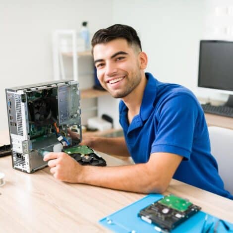 smiling man fixing a pc