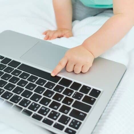 toddler crawling up t laptop