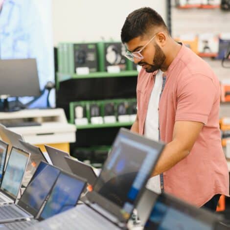 a man at a computer store shopping for a new computer