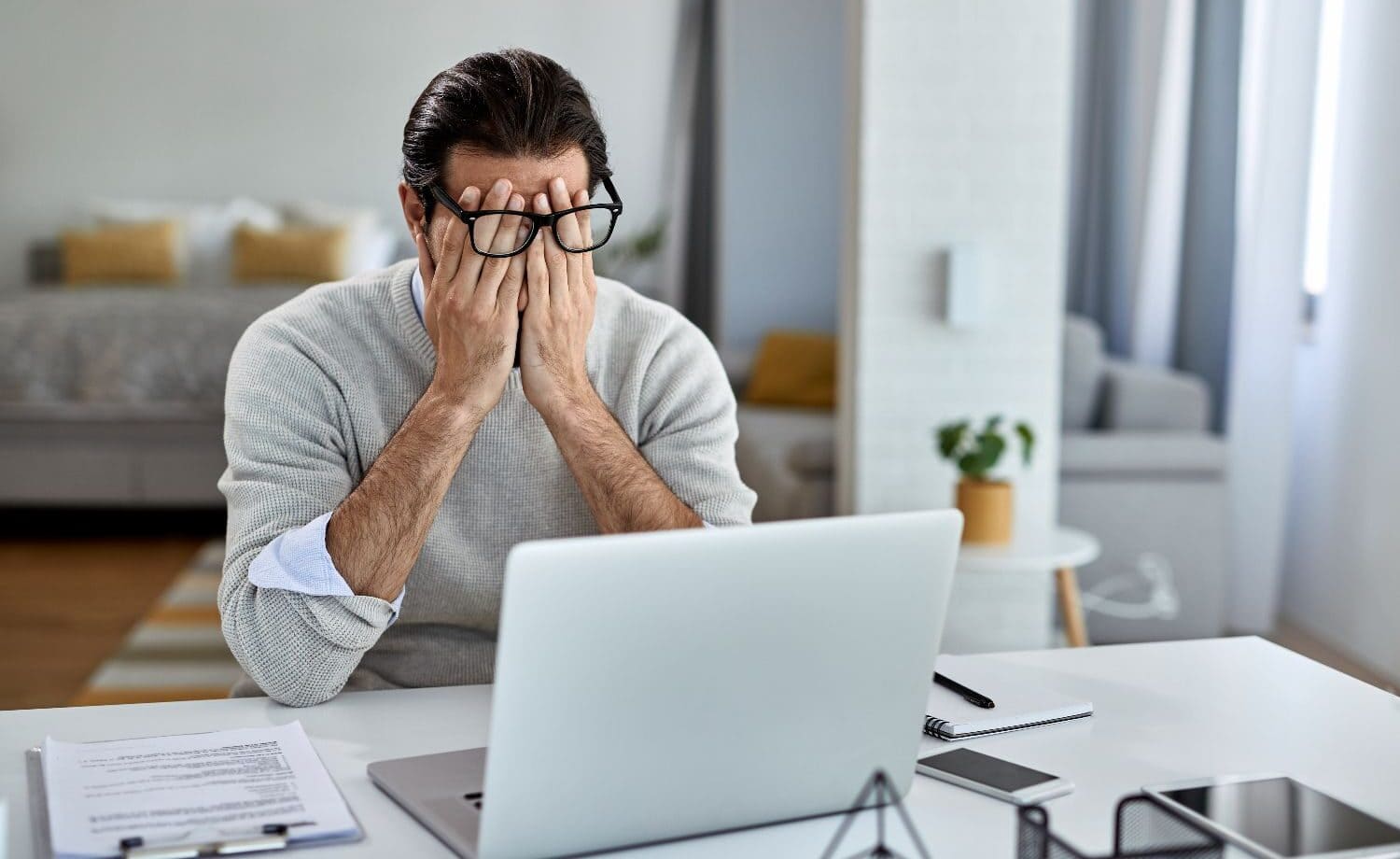 a man who is stressed out by a dead computer