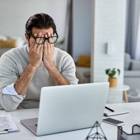 a man who is stressed out by a dead computer