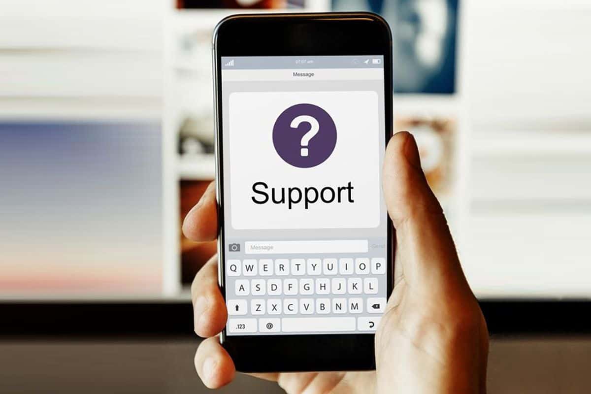 Hand holding a smartphone with a 'support' question mark icon, emphasizing Geeks On Command's smartphone support services.