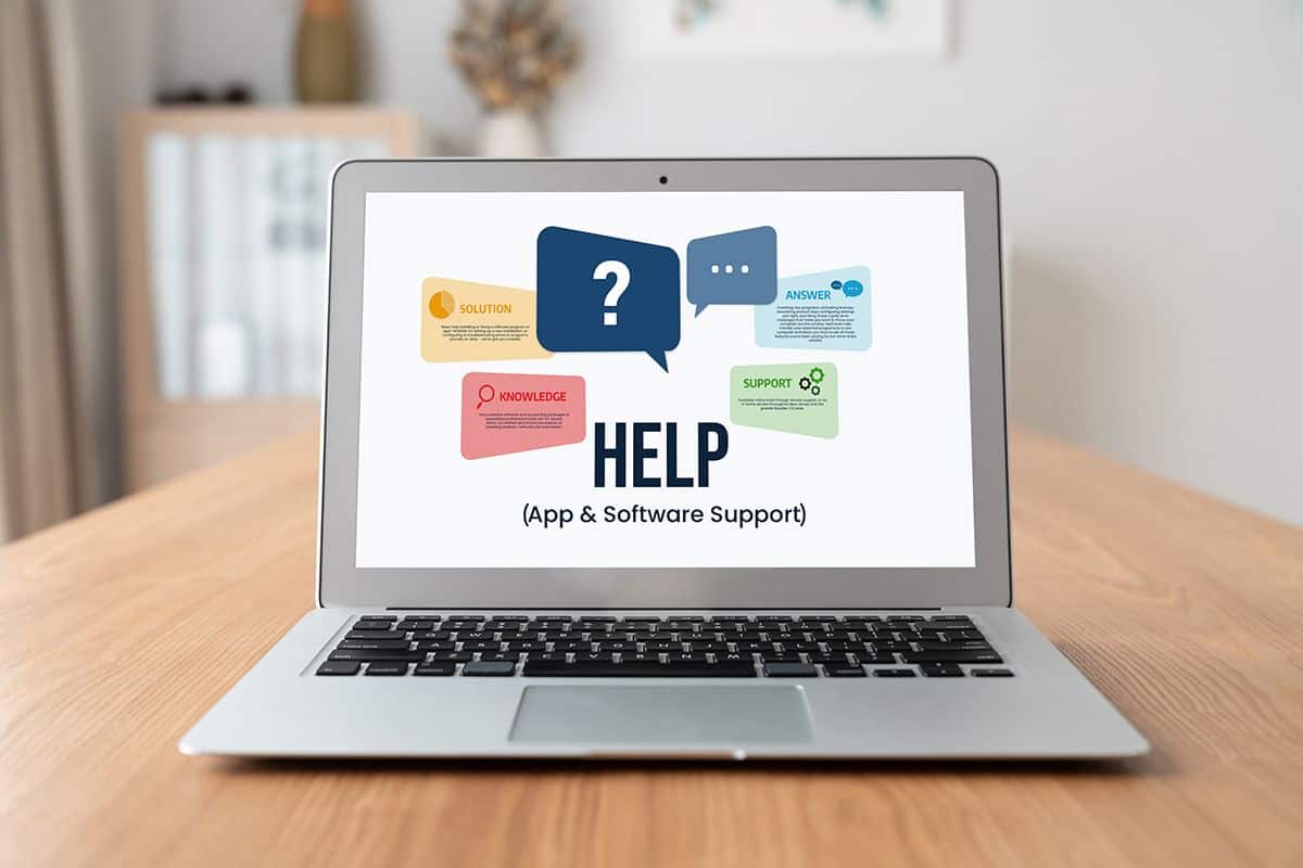 Laptop screen displaying a help page with keywords like solution, support, and knowledge, representing software and application support services.