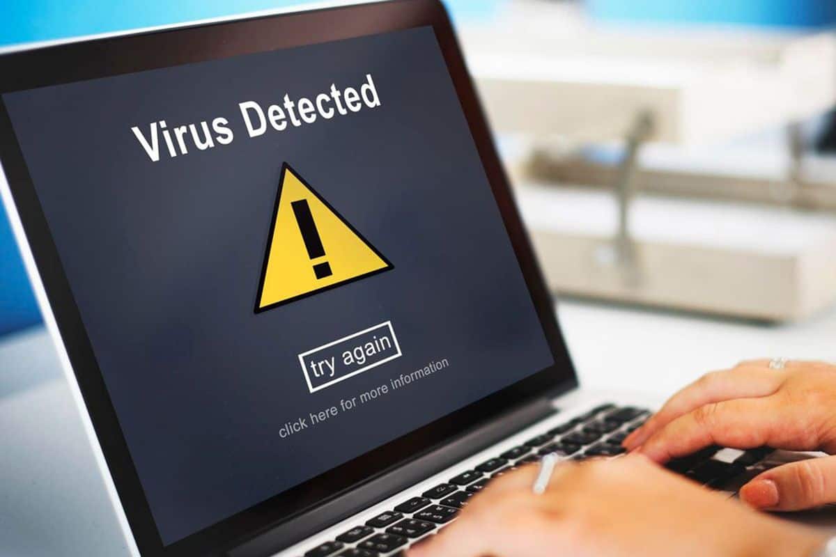 Laptop screen displaying a 'virus detected' warning, symbolizing Geeks On Command's virus removal services to protect devices.