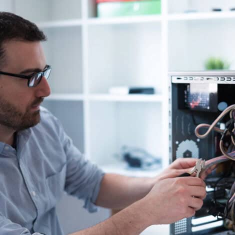 Computer Repair Technician fixing a desktop tower computer