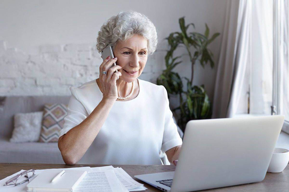 Woman at home in front of her laptop calling to schedule computer service with Geeks On Command.