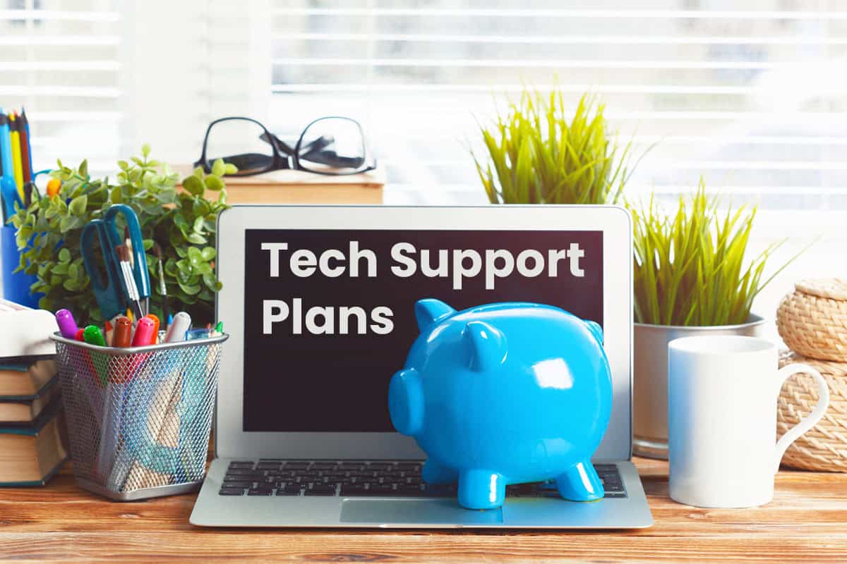 Laptop displaying "Tech Support Plans" text on the monitor, with a piggy bank placed on its keyboard, ostensibly to represent the Geeks On Command Tech Support Savings Plan